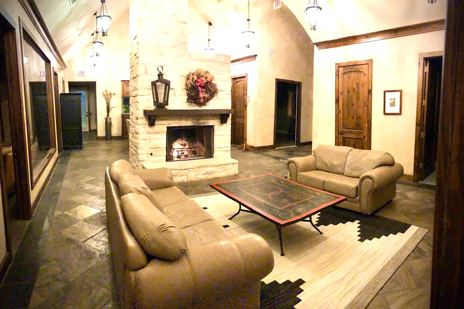 The lobby of Sugar Land Counseling Center with a stone fireplace and leather sofas